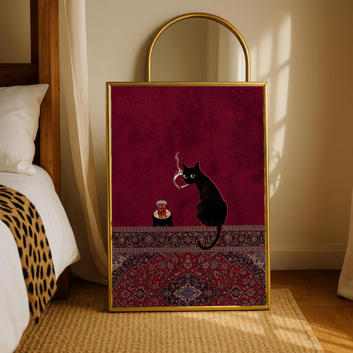 Black cats, tea glass and smoking motif in a warm wood frame on a bedroom floor beneath an arched mirror