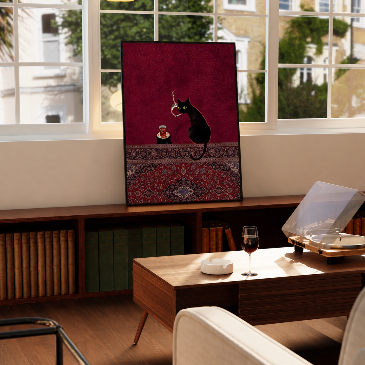 Black cats, tea glass and smoking motif in a black frame on a windowsill above a green radiator, with a turntable nearby
