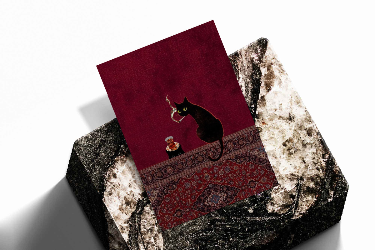 Black cats, tea glass and smoking motif as an unframed print propped against a pale wall on a rough stone