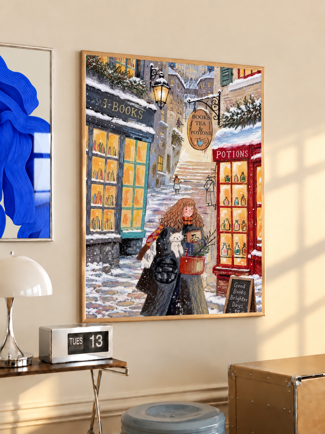 Wall-hung framed snowy street print with red-haired girl and white cat