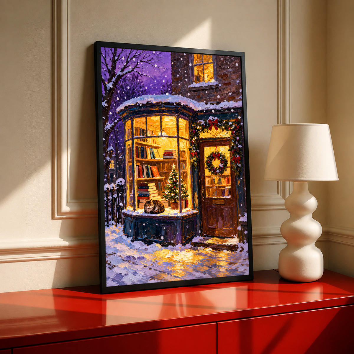 Black-framed Christmas bookshop print with a cat in the window and snowy street