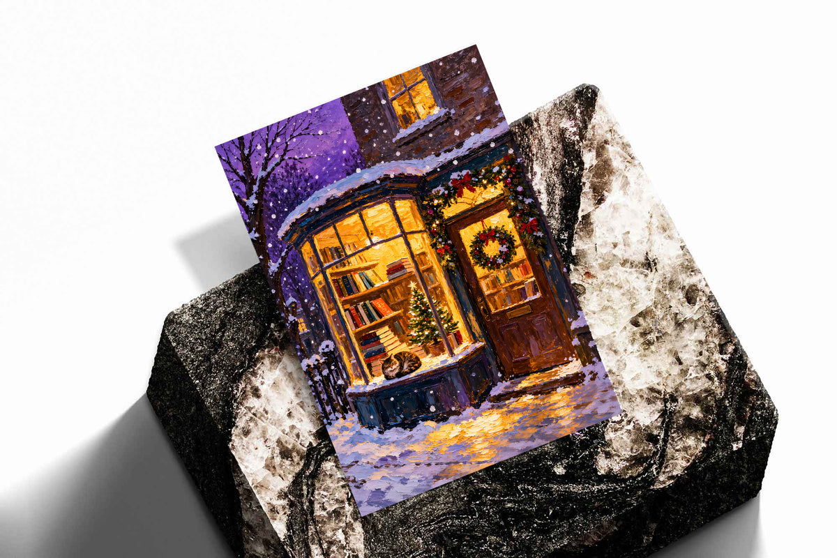 Christmas bookshop art print with a cat in the window, books and a lit holiday tree