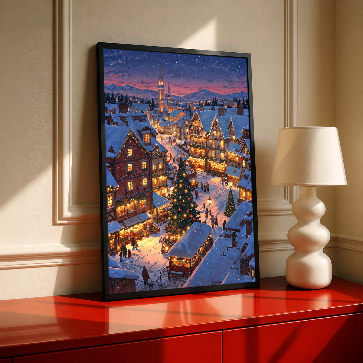 Tall black-framed snowy village wall print with lit houses and decorated trees