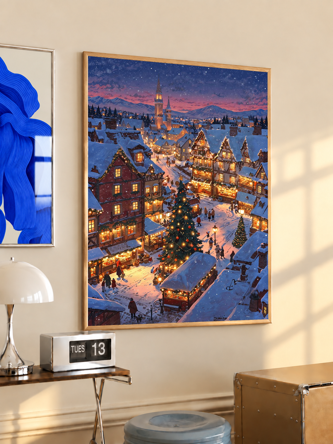 Blue twilight winter village wall print with glowing stalls, in a dark frame