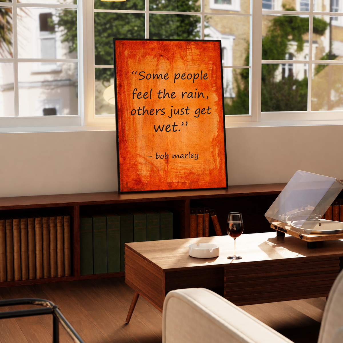 Framed quote poster on orange textured background reading “Some people feel the rain”