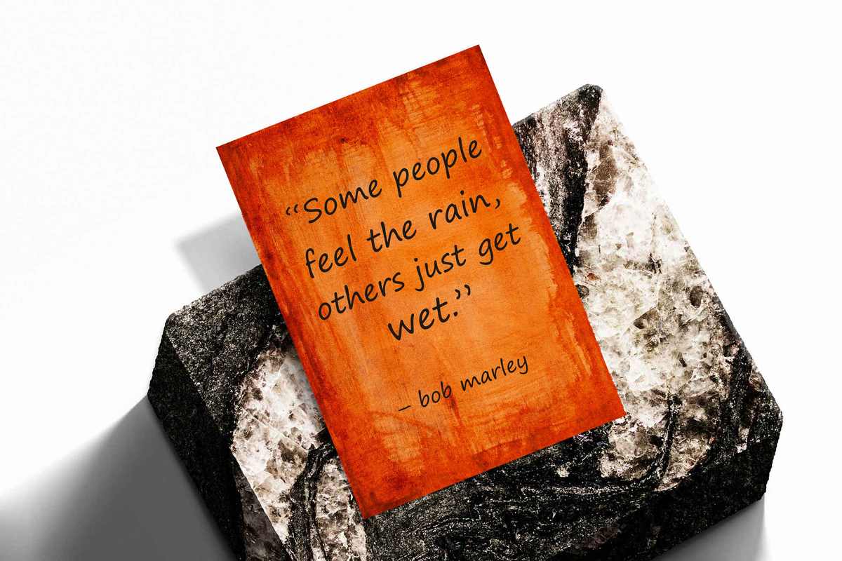 Framed quote poster on a stone surface with orange textured background and “wet” quote