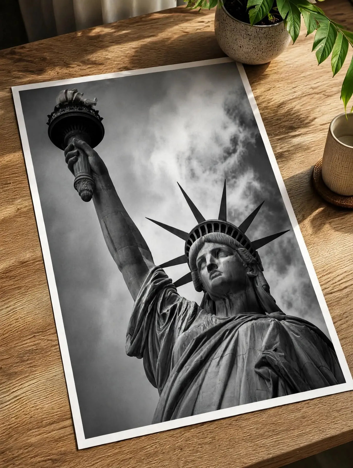 Black-and-white Statue of Liberty art print with white border on wooden table