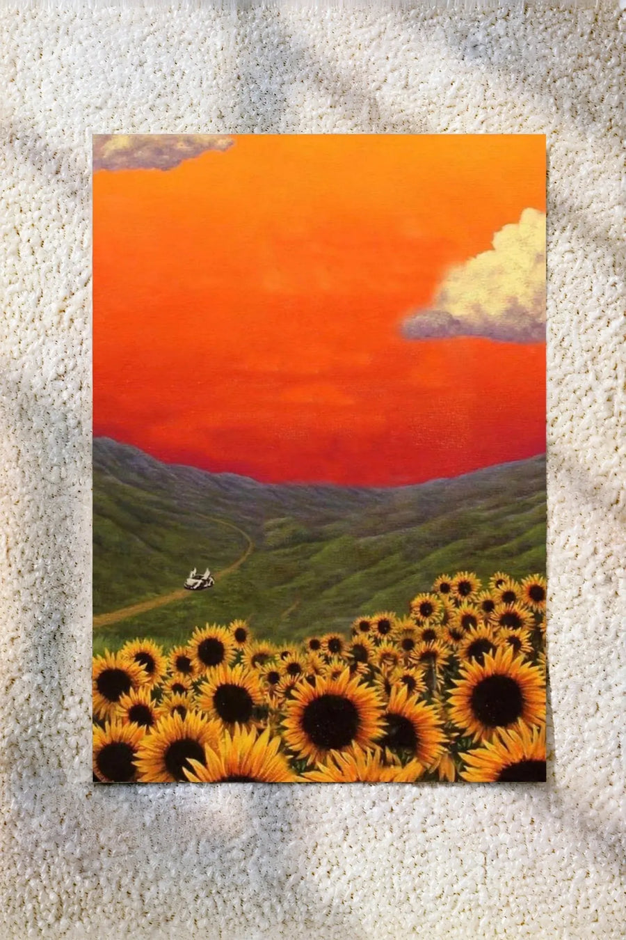 Sunset landscape wall art print with orange sky, clouds, rolling hills, and yellow sunflowers