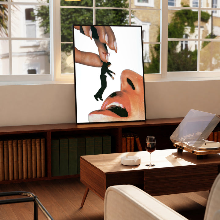 Framed surreal collage poster with giant hand, small standing figure, and open mouth artwork