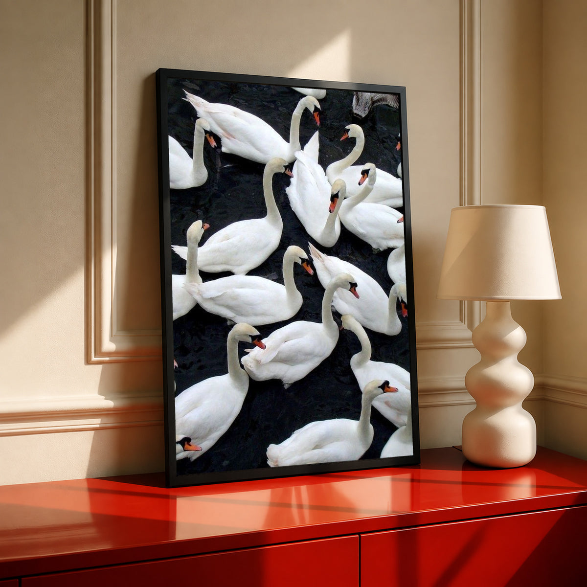 Framed wall art print of white swans on dark water with visible beaks