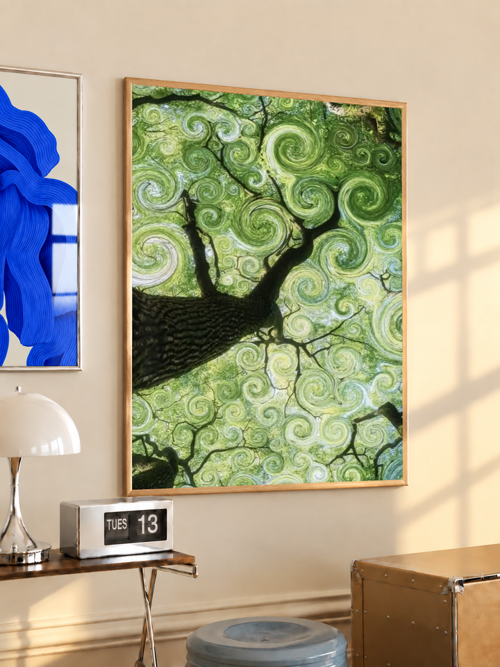 Swirling green tree canopy in an oak frame on a warm cream wall above a small table and dome lamp