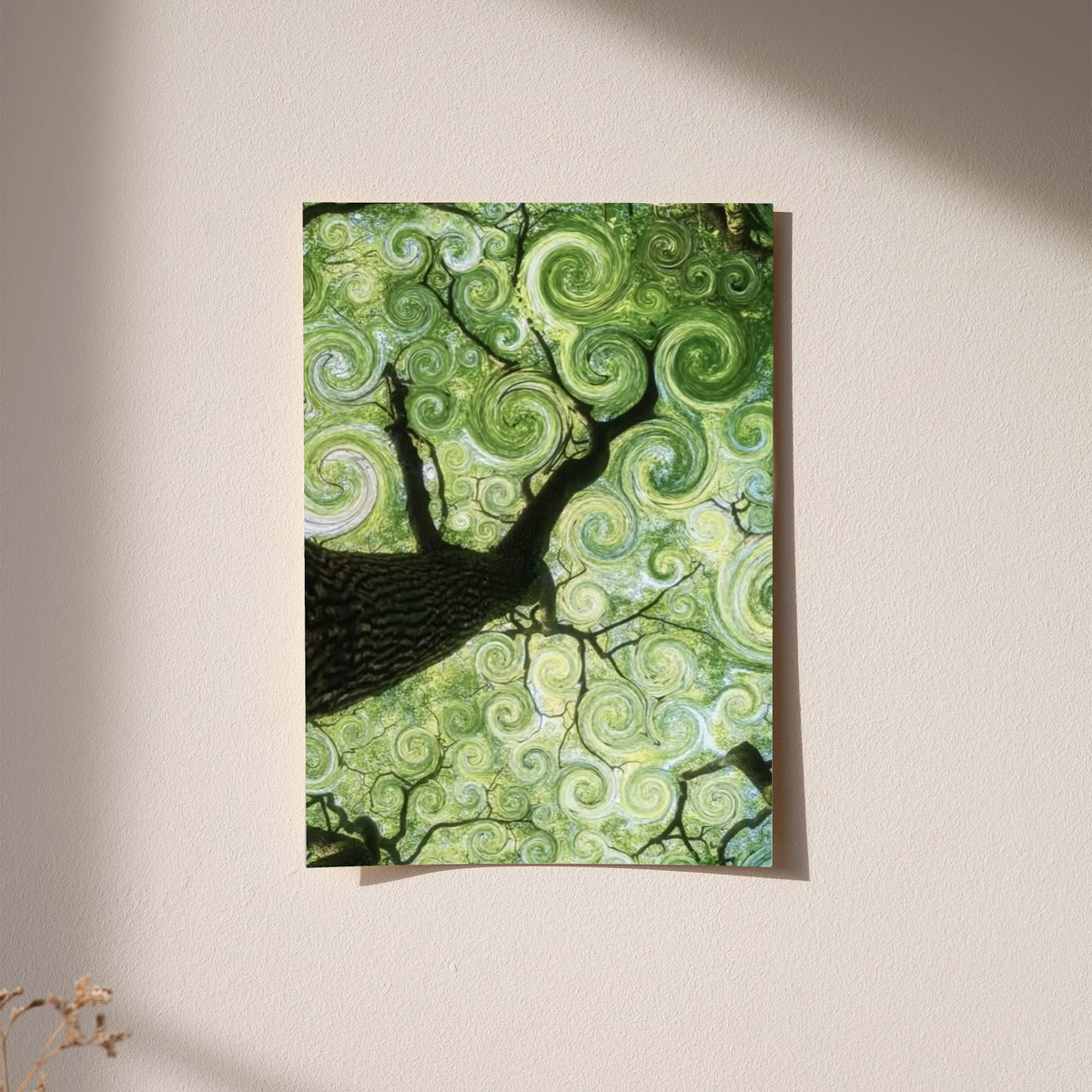 Swirling green tree canopy as an unframed print against a pale plaster wall with soft shadows