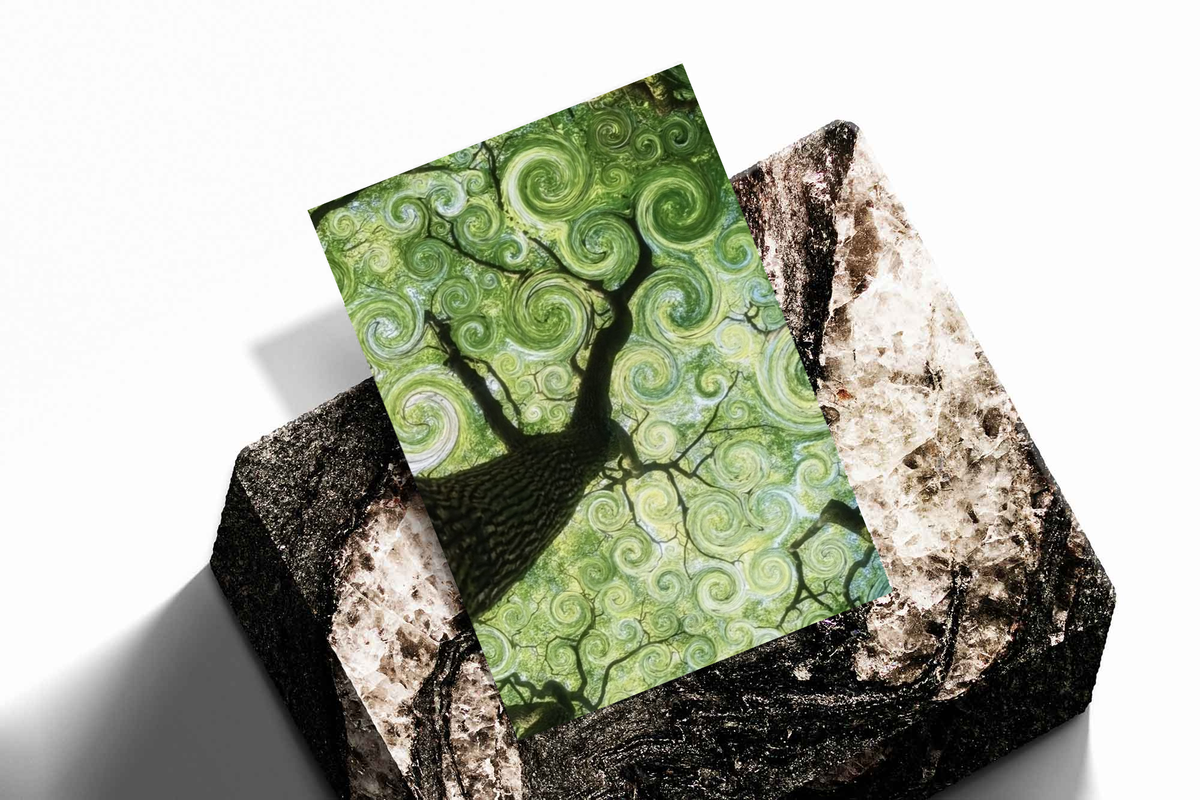 Swirling green tree canopy as an unframed print propped against a pale wall on a rough stone