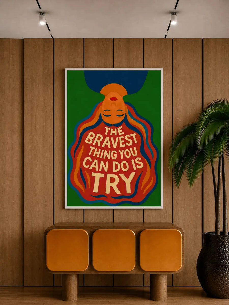 Impresión de arte mural enmarcada con fondo verde, figura naranja y texto “THE BRAVEST … TRY”