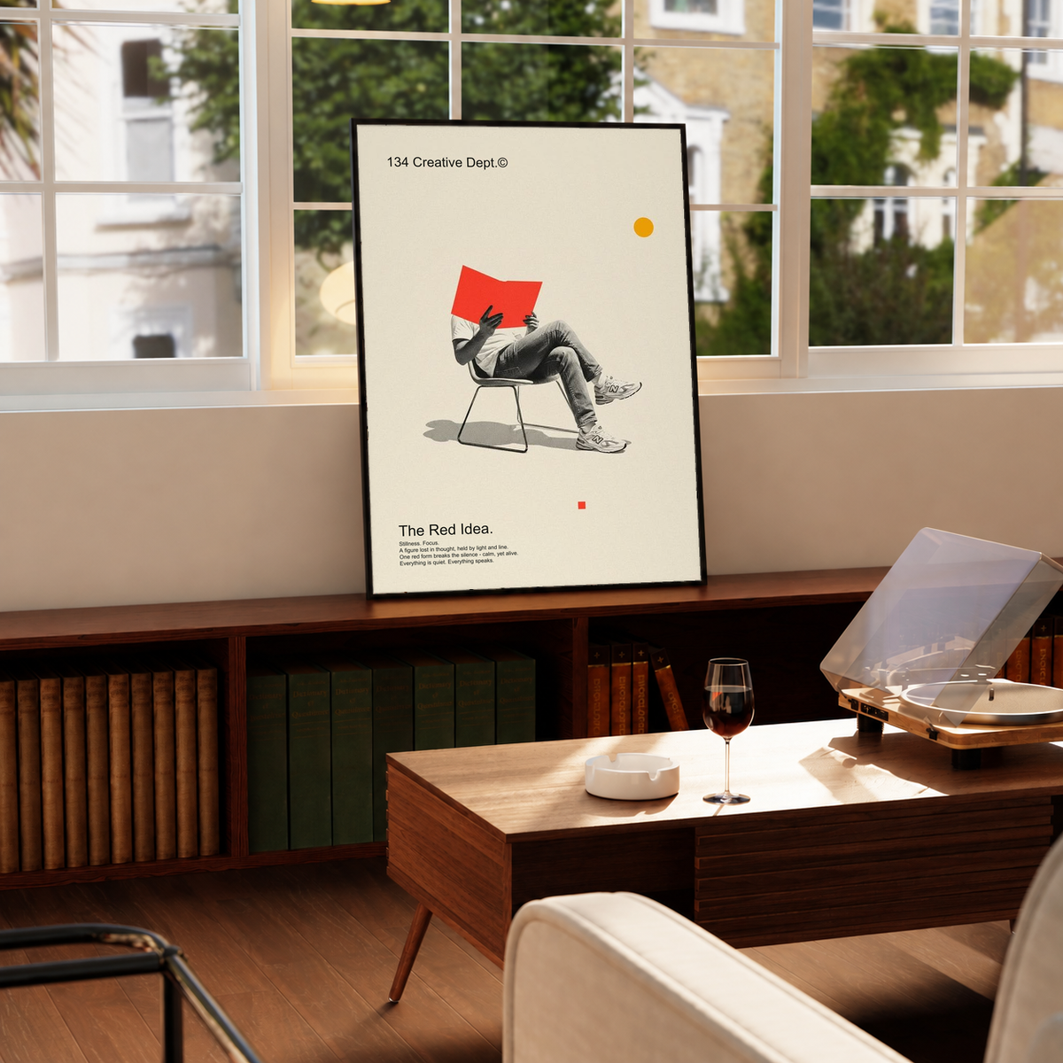 Framed collage poster with red chair figure on cream background, black frame