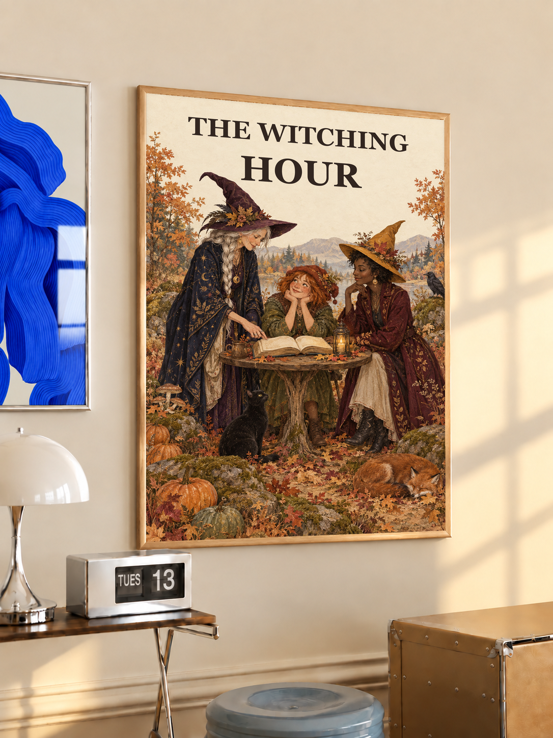 Light wood–framed Witching Hour art print with three witches at a lit open book