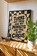 Framed wall art with black frame, checkered border, and bold quote text on beige