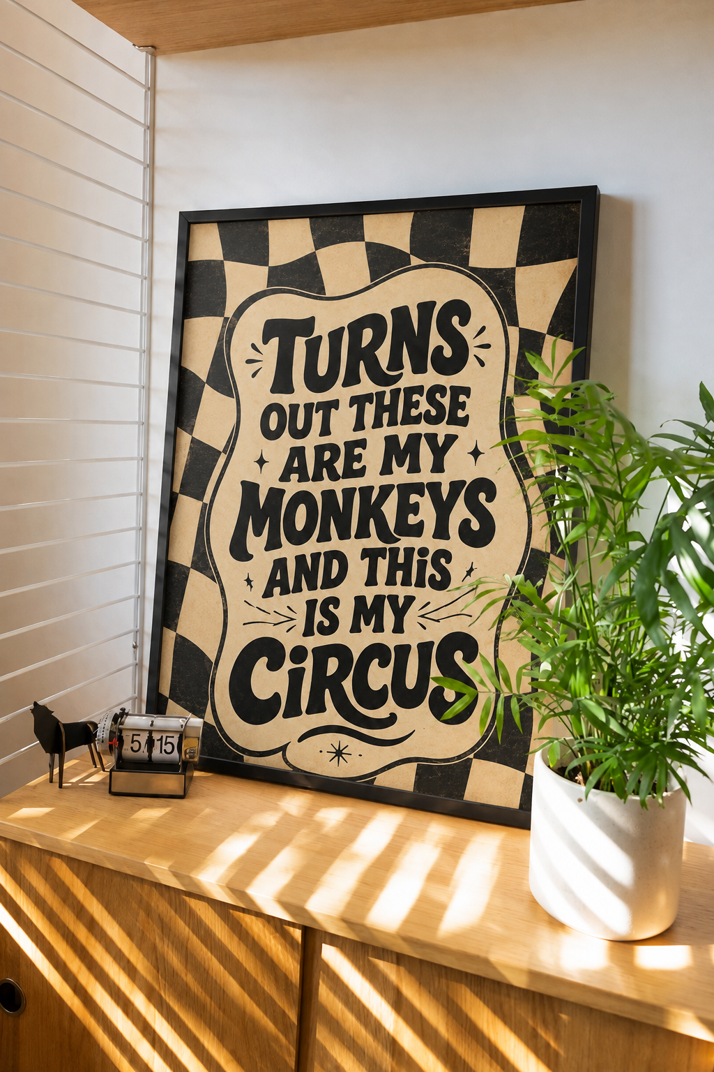 Framed wall art with black frame, checkered border, and bold quote text on beige