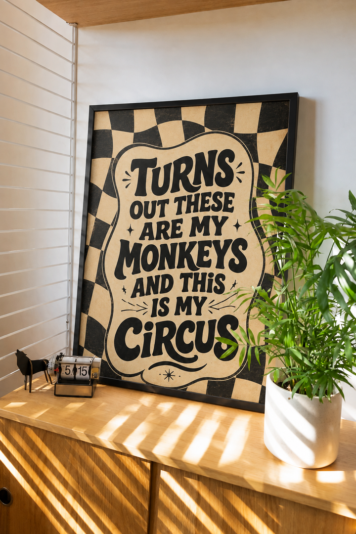 Framed wall art with black frame, checkered border, and bold quote text on beige