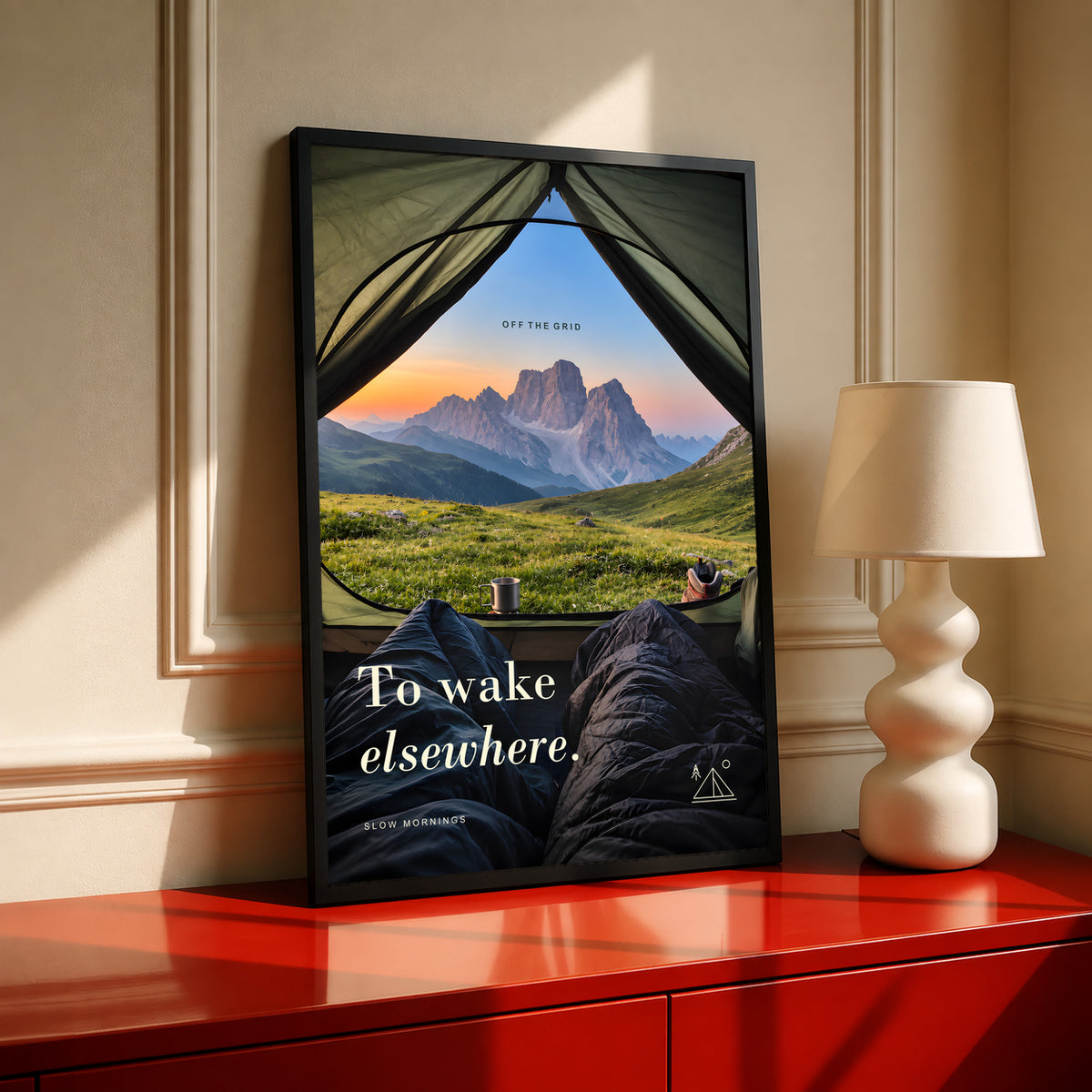 Camping poster in a black frame, showing a mountain view from inside a tent.