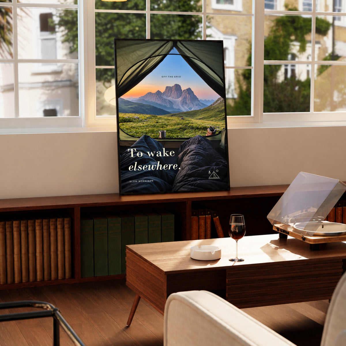 Camping poster with a tent-framed view of mountain peaks and green hills.