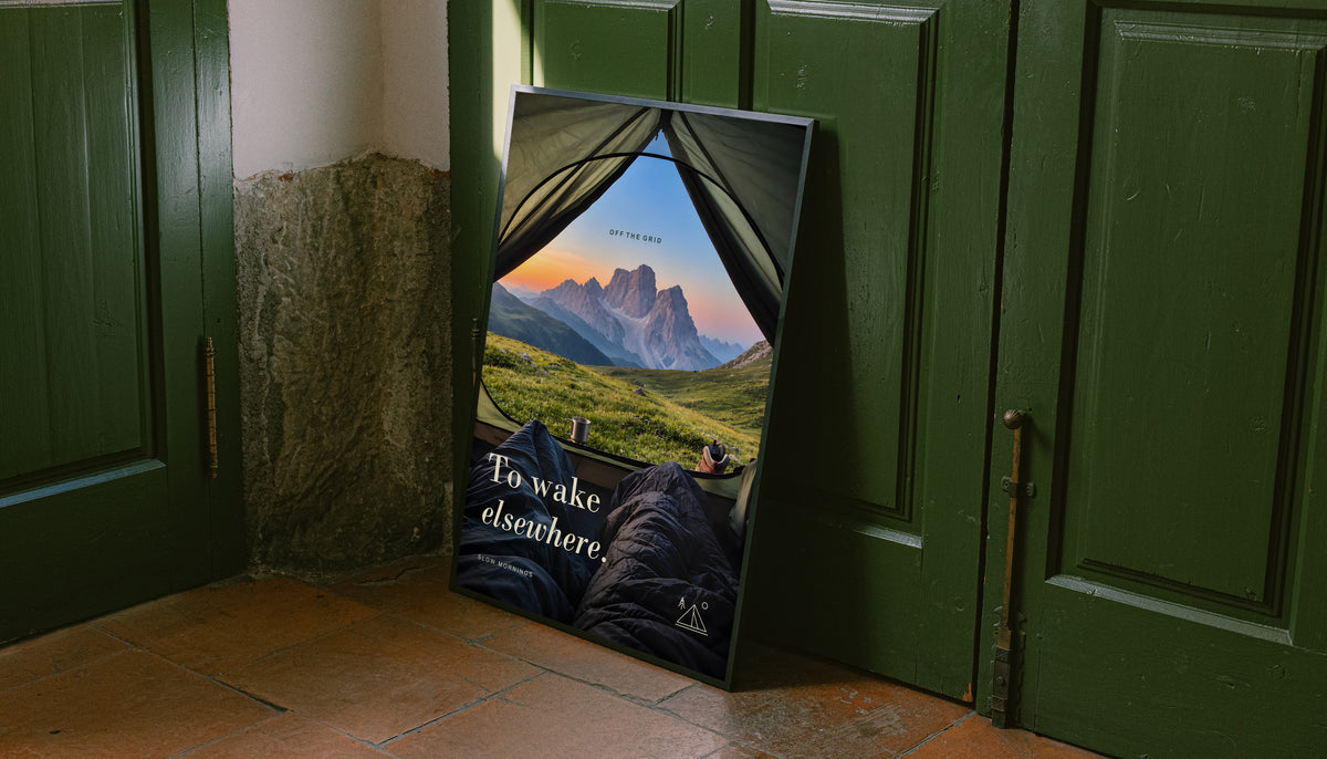 Camping poster leaning against a door, depicting mountain scenery viewed from a tent.