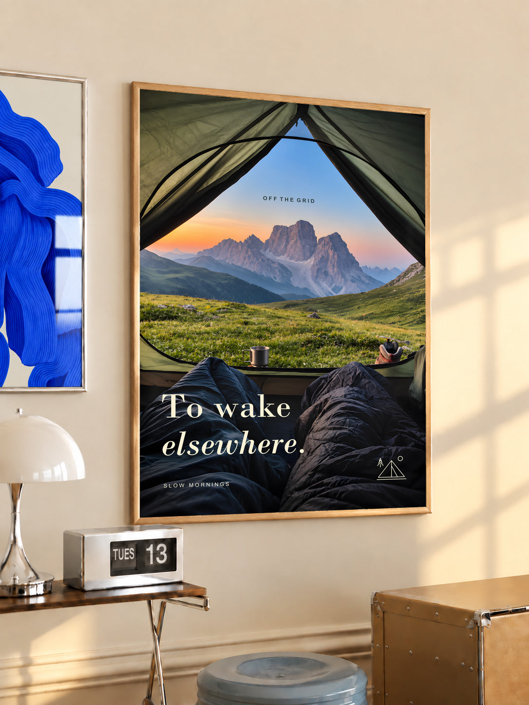 Camping poster in an oak frame, featuring a mountain view from inside a tent.