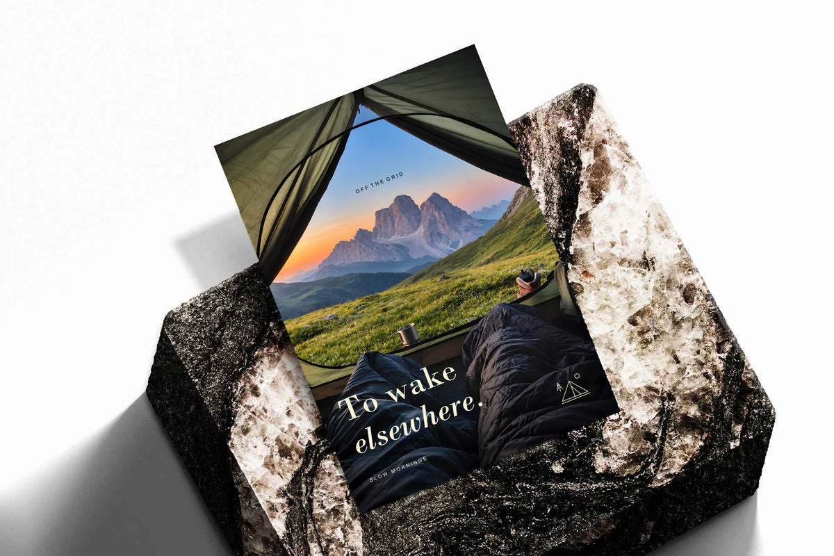 Camping poster showing mountain scenery framed by an open tent.