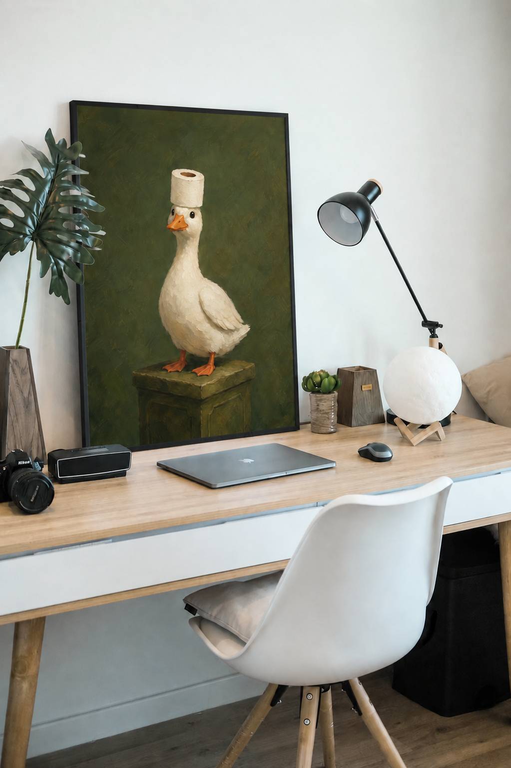 Framed goose wall art on green background, toilet-roll holder on pedestal