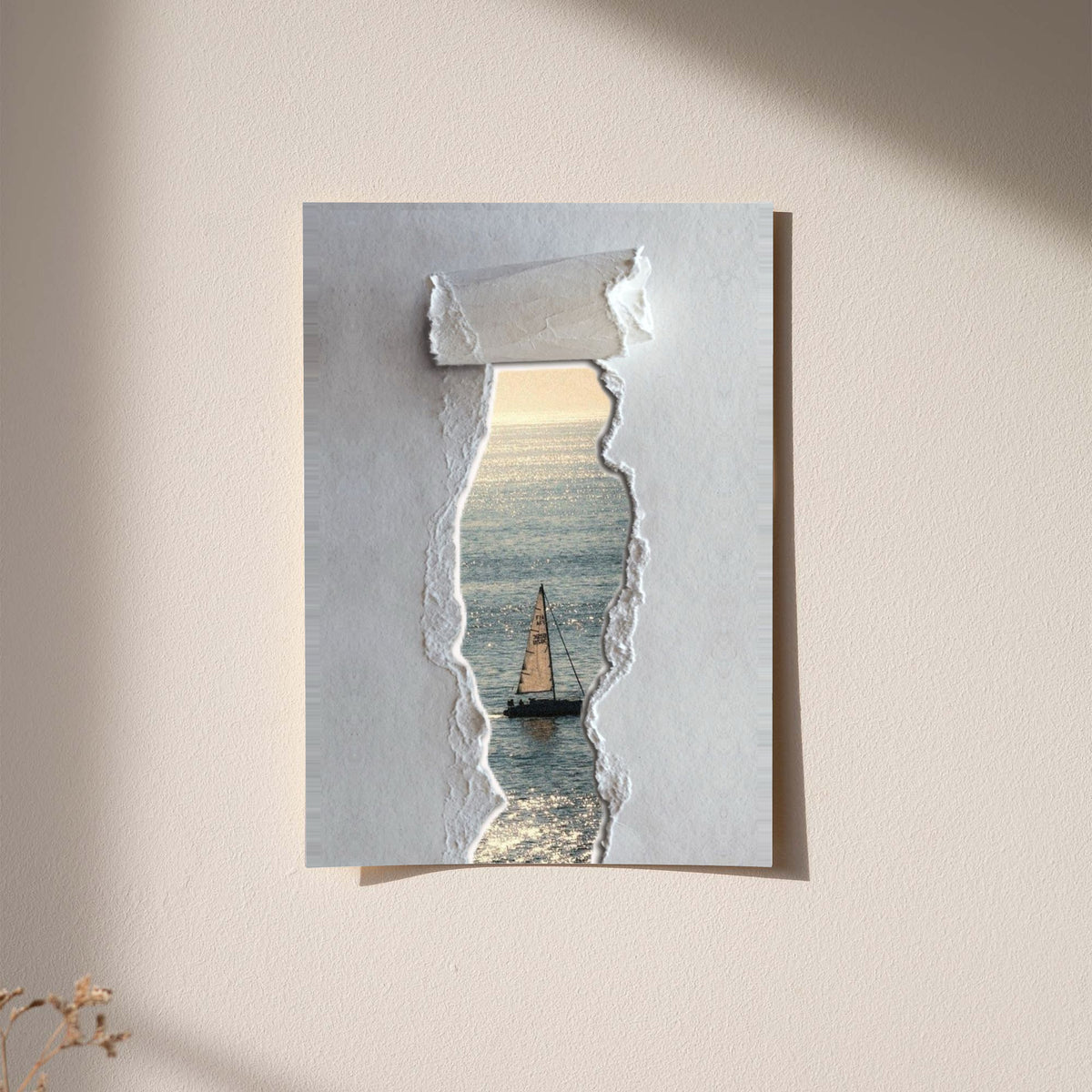 A sailboat at sea seen through a printed torn-paper opening on a grey ground displayed without a visible frame on a softly lit pale wall