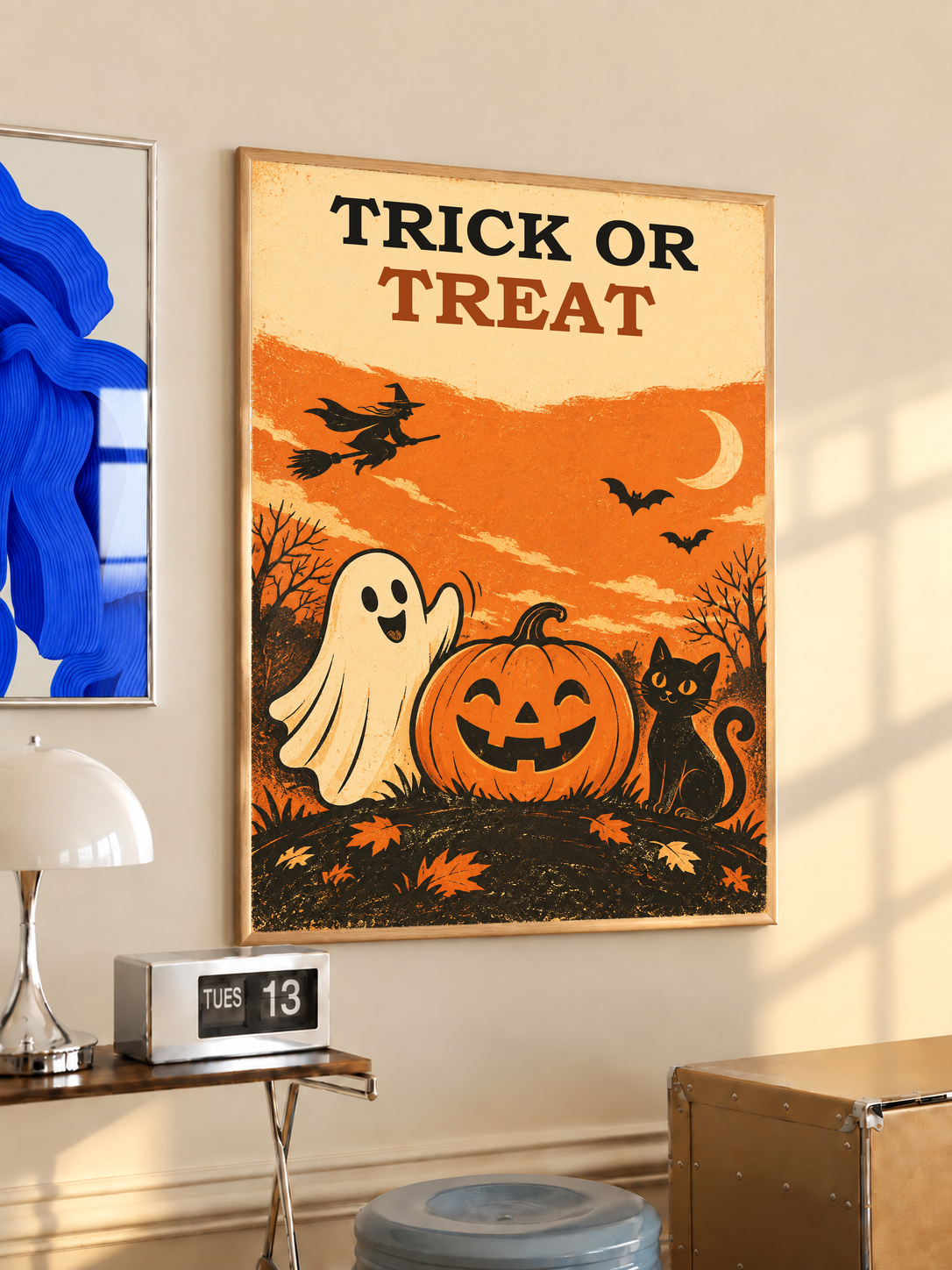 Gold-framed Halloween poster showing “Trick or Treat,” ghost, jack-o’-lantern, bats, cat
