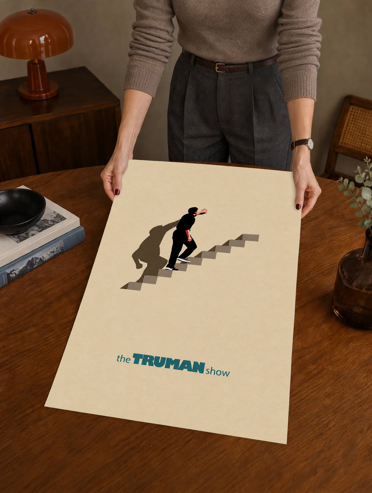 Staircase poster held by person, lone figure on steps on beige background