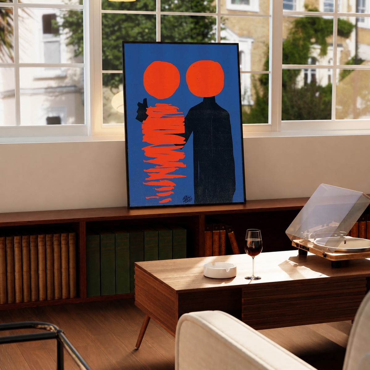 Framed abstract poster with two orange circles, a black figure, and red stacked lines on blue