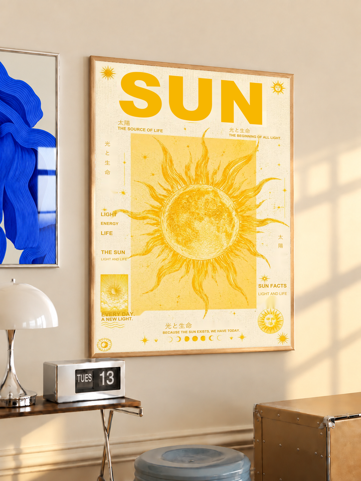 Sun typography and solar illustration in an oak frame on a warm cream wall above a small table and dome lamp