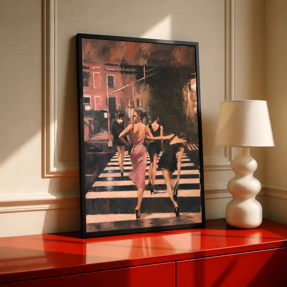 Black framed wall art with women in a pink dress walking down a striped crosswalk street