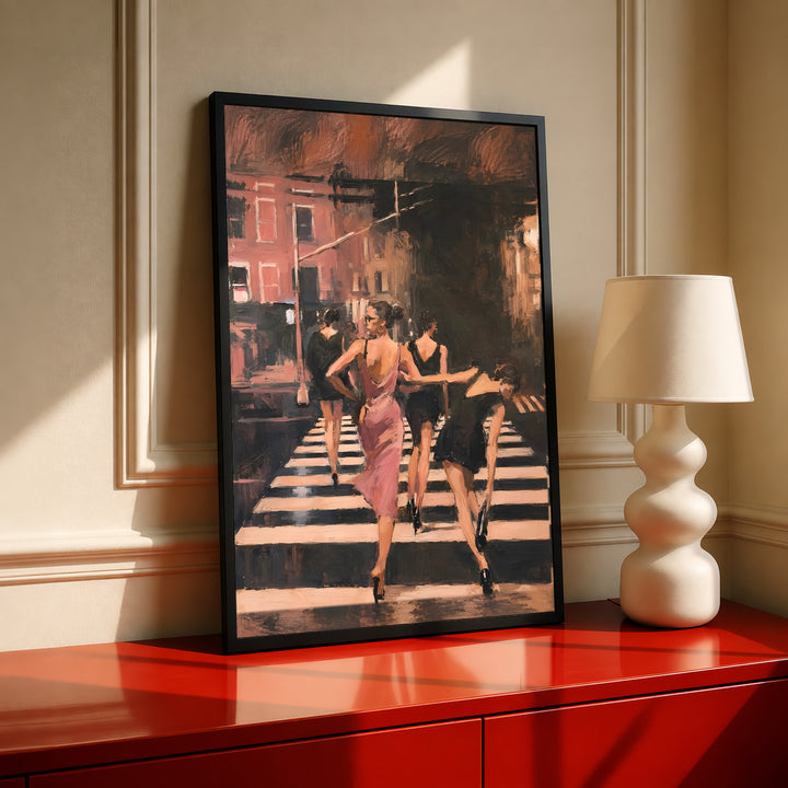 Black framed wall art with women in a pink dress walking down a striped crosswalk street