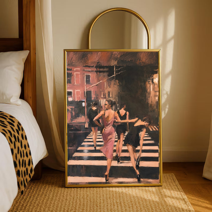 Gold framed wall art featuring women in a pink dress walking on a striped crosswalk