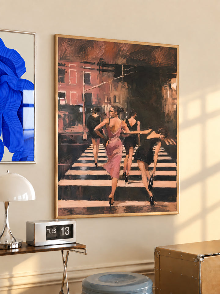 Light wood framed wall art showing women in a pink dress walking on a striped crosswalk
