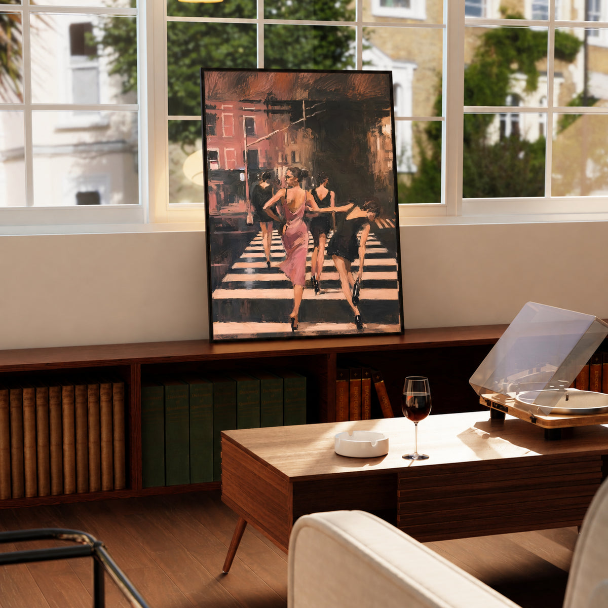 Wood framed street scene wall art of women in a pink dress walking on a striped crosswalk
