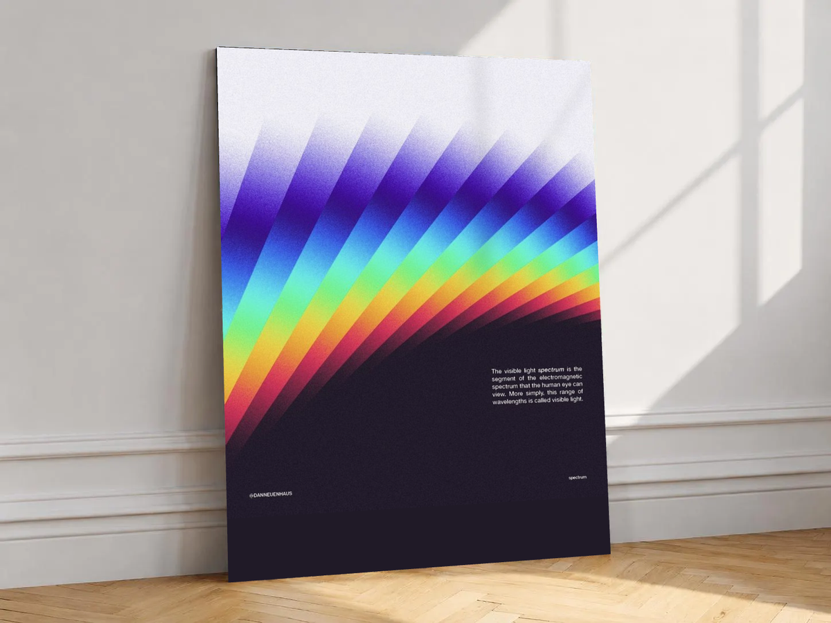 Canvas artwork depicting diagonal bands of visible-spectrum colors, leaning against a white wall in angled sunlight.