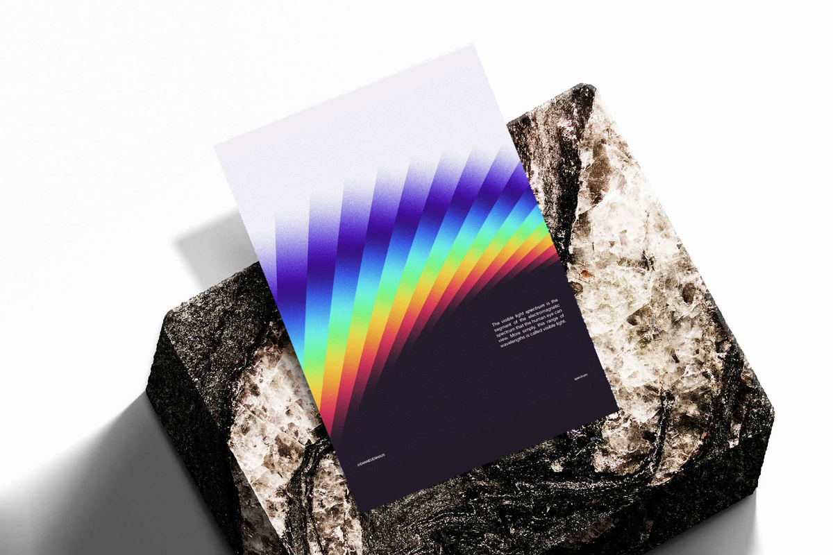 Unframed artwork depicting diagonal bands of visible-spectrum colors, presented diagonally on rough stone.
