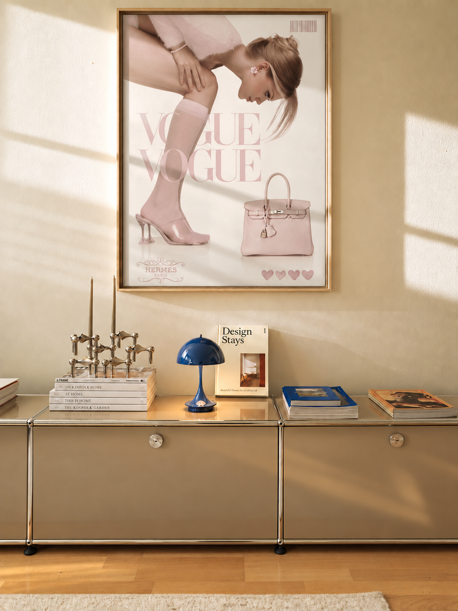 Framed fashion poster in oak frame with pink Vogue-style ad and handbag