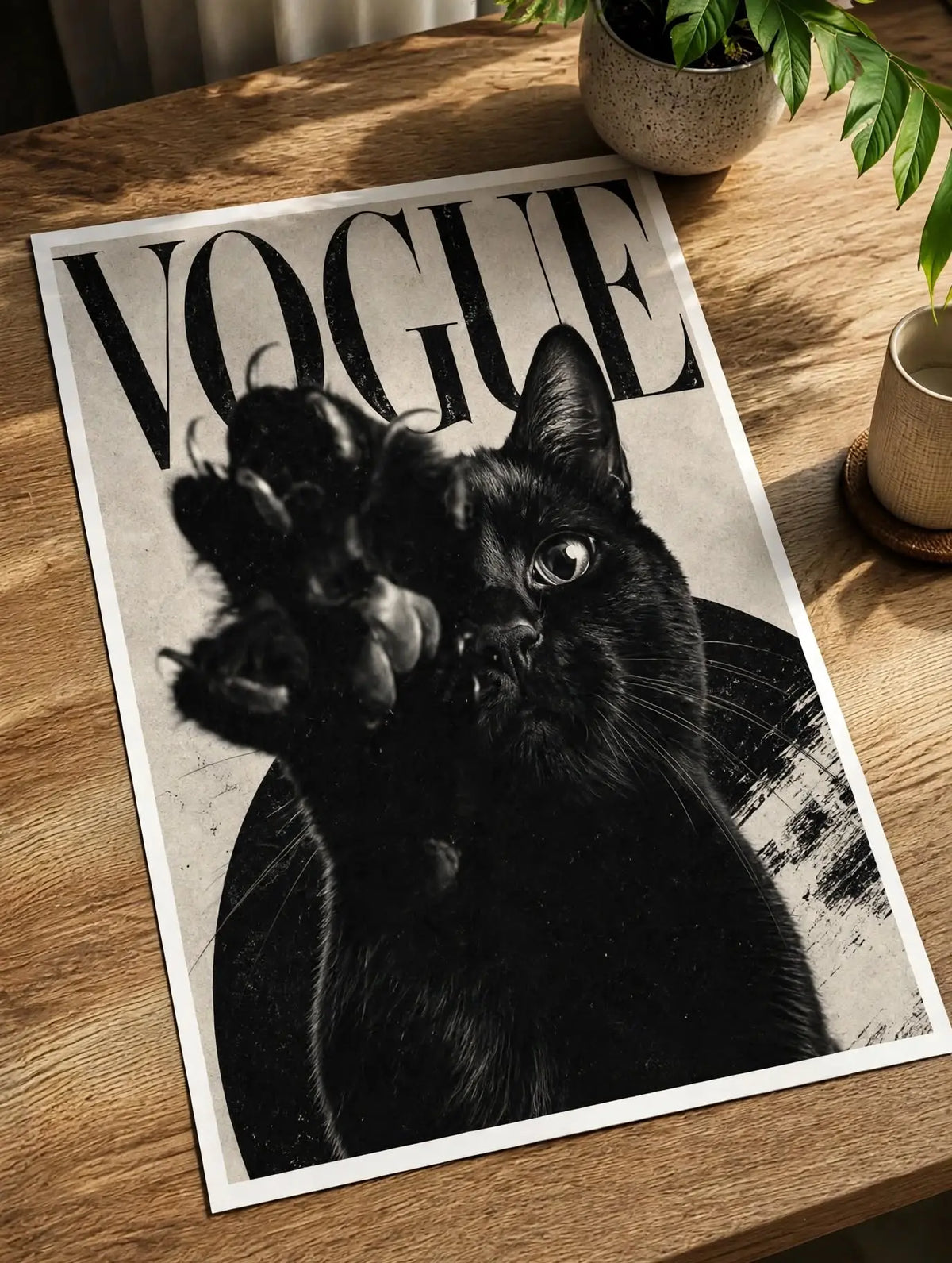 Black cat portrait art print on a wooden surface, “VOGUE” text across the top.