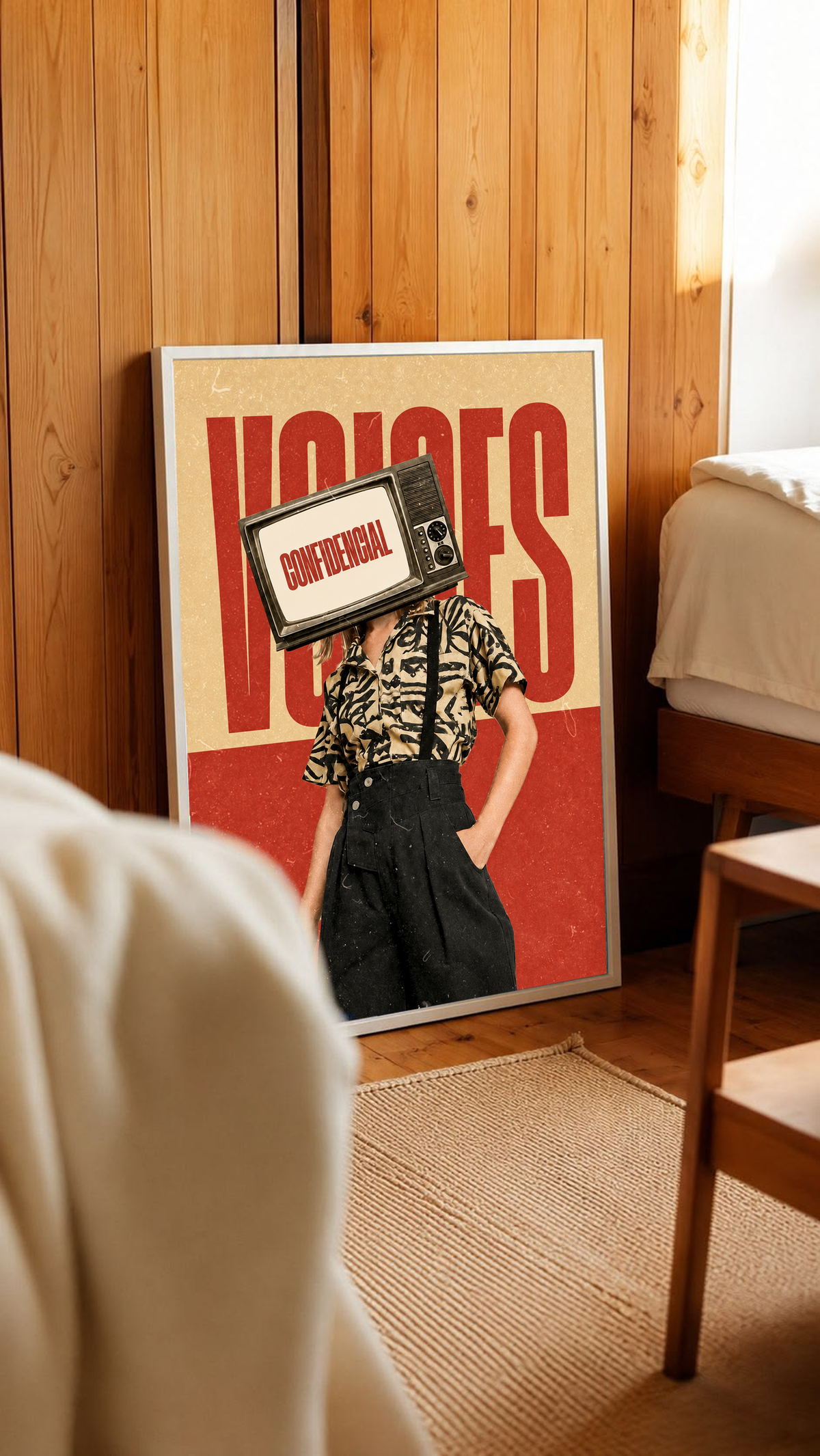 A television-headed figure in a patterned shirt before red Voices lettering in a white frame leaning against warm wooden wall panels
