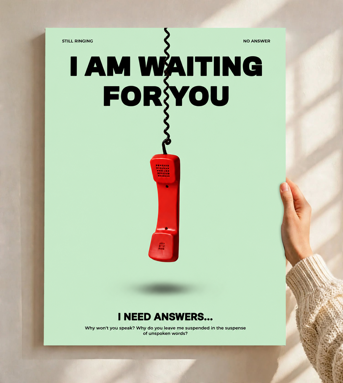 A suspended red telephone receiver and Waiting for You lettering on mint green as an unframed poster held against a pale sunlit wall