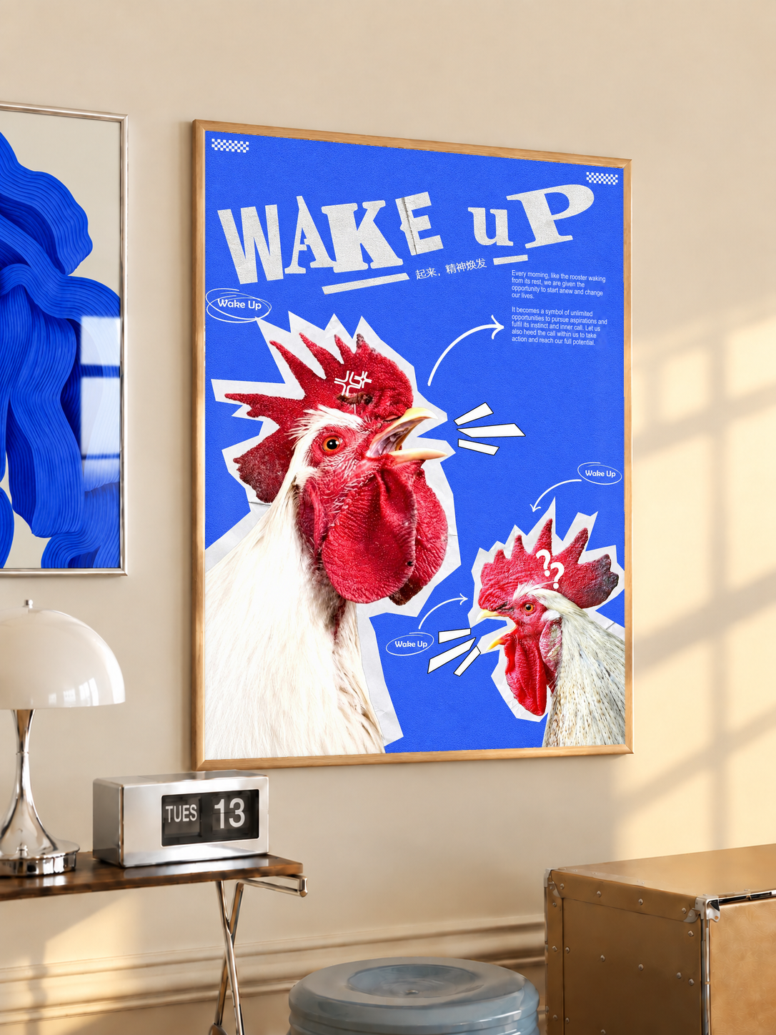 Red and white rooster cutouts with Wake Up lettering on cobalt blue; oak framed print in a desk setting