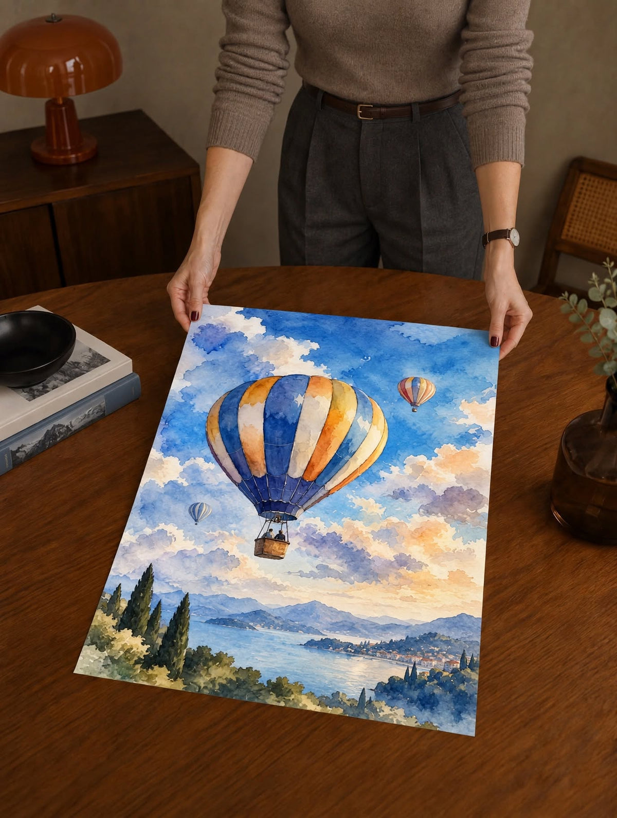 Hot Air Balloon Watercolor Art Print shown as an unframed physical artwork over a dark wooden table