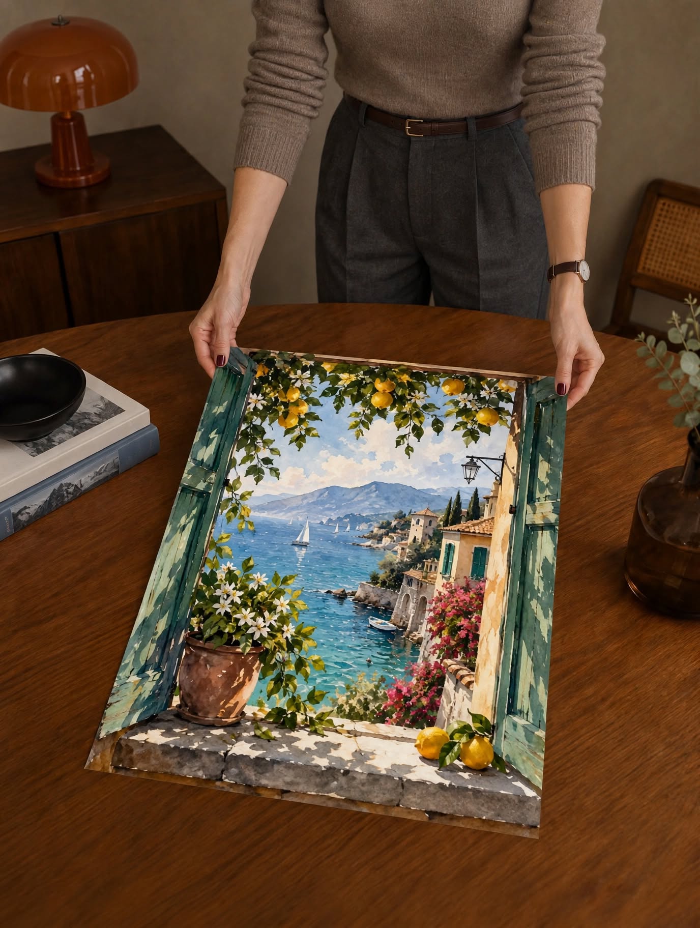 Mediterranean View Watercolor Art Print laid on a dark wooden table, highlighting vivid blue water and loose painterly garden details