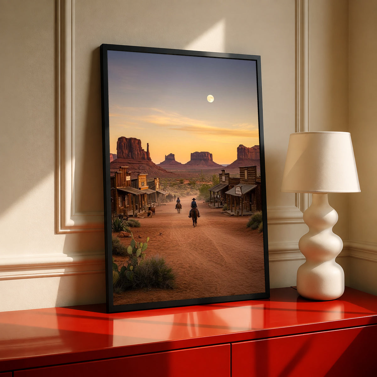 Black-framed western desert town sunset poster with riders on a dusty road