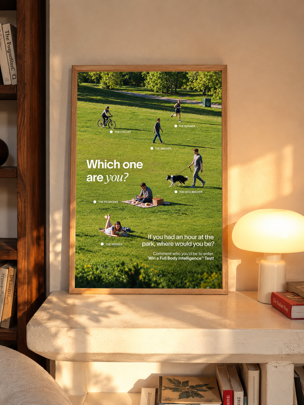 Six park activities labelled across a green lawn beneath Which One Are You text in an oak frame above a pale wooden sideboard beside a glowing lamp